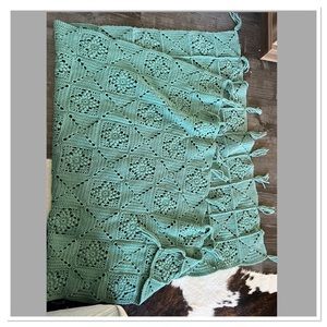 Crocheted green blanket throw